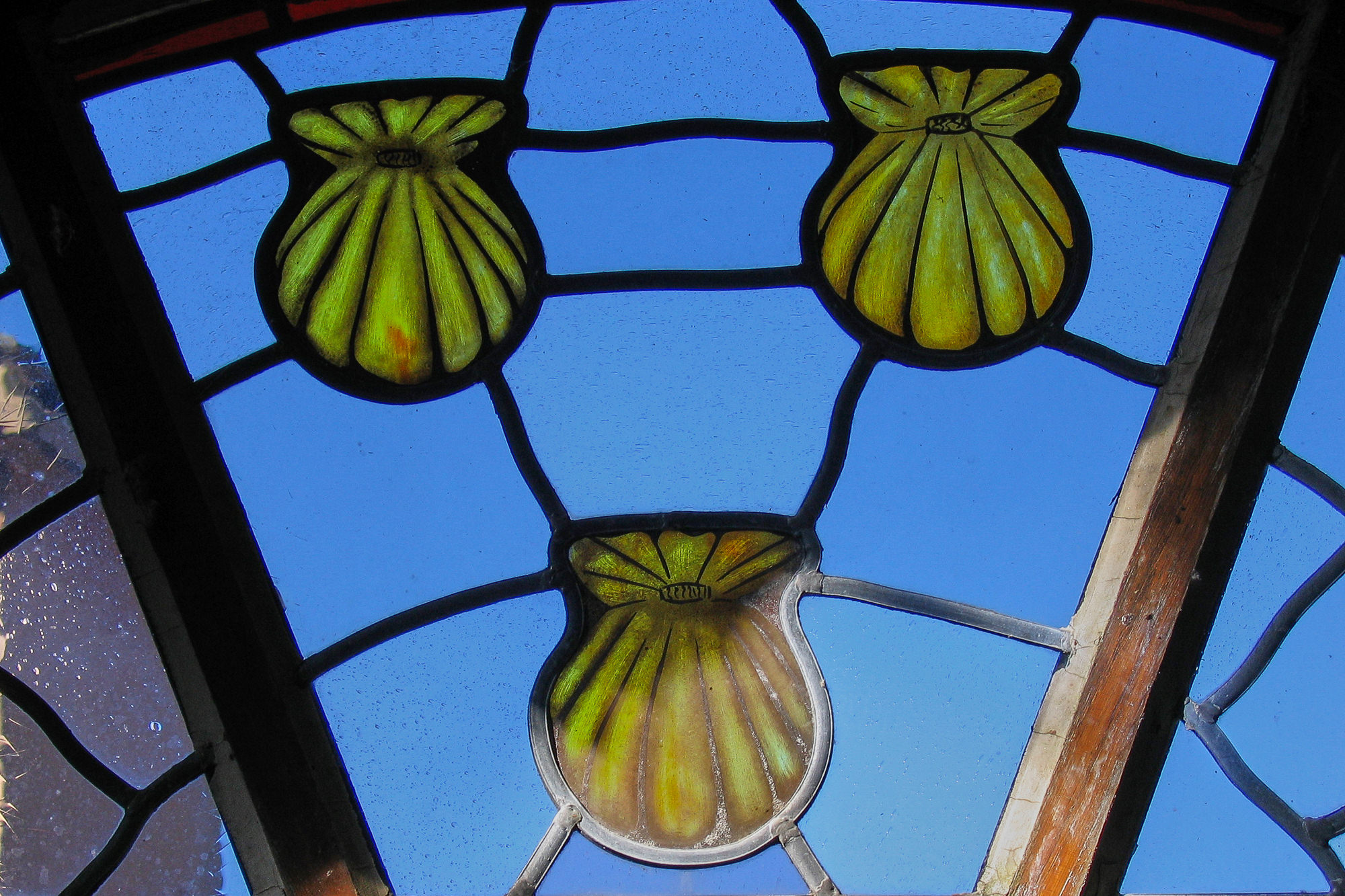 Day 6: From Espeyrac to Conques, Way of St. James landmark in a window